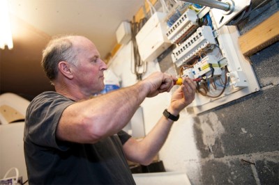 Ian Christie working on a fuseboard replacement in a North Dublin home  - providing electrician services to Clontarf, Artane, Howth, Fairview, Raheny, North East Dublin, Ireland